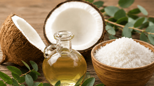 oil flask with coconut, eucalyptus leaves and bowl of salt 